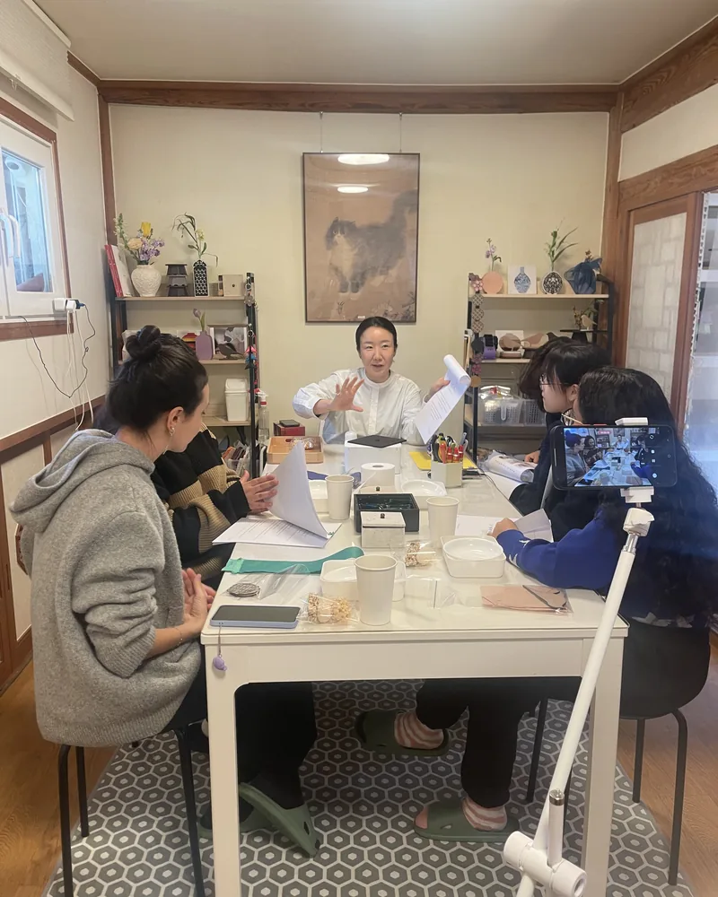Instructor with participants in a hanji class